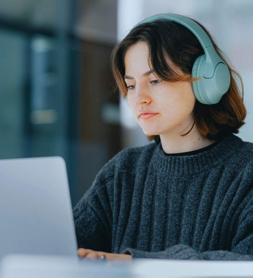 woman using laptop with headphones on